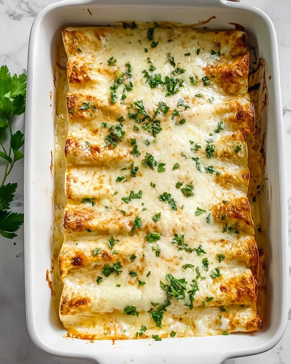 A white square baking dish filled with six rolled enchiladas neatly arranged side by side, covered with a thick layer of melted, gooey white cheese that has slightly browned spots around the edges, creating a golden crust. The enchiladas vary in shades of light yellow and soft brown, visible through the cheese layer, showing a soft, crepe-like texture. Bright green chopped parsley is sprinkled evenly on top, adding a fresh contrast. The dish sits on a white marbled surface, emphasizing the warm tones of the baked food. Photo taken with an iphone --ar 4:5 --v 7