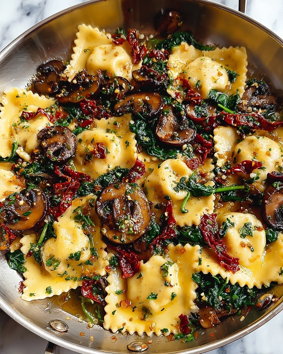 The dish shows one layer of square ravioli pasta with a pale yellow color, topped with several layers of cooked dark green spinach leaves, a generous amount of sliced brown mushrooms, and thin strips of dark red sun-dried tomatoes, all lightly coated with a glossy sauce sprinkled with small green herbs and red chili flakes, served in a silver pan resting on a white marbled texture. photo taken with an iphone --ar 4:5 --v 7