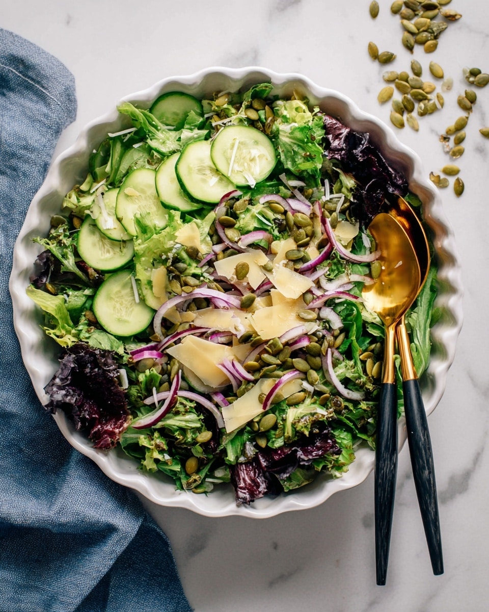 A fresh green salad is shown in a white bowl on a white marbled surface, with layers including mixed leafy greens with different shades of green and some dark purple leaves at the bottom. On top, there are thinly sliced cucumber rounds, avocado slices, thin purple onion slices, and scattered green pumpkin seeds. A light yellow dressing is being poured from a white container over the salad, creating a shiny texture on some parts. A gold fork is partly visible on the left side. The photo taken with an iphone --ar 4:5 --v 7