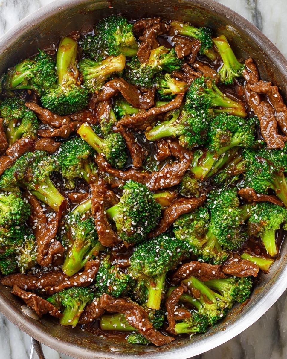 A black rectangular container holds a dish with two visible layers. The bottom layer is plain white rice, spread evenly across the container. The top layer consists of stir-fried pieces of brown beef and bright green broccoli florets, scattered evenly over the rice. The beef and broccoli are coated in a glossy dark brown sauce, and the dish is sprinkled with small white sesame seeds. The scene is set on a white marbled texture. photo taken with an iphone --ar 4:5 --v 7