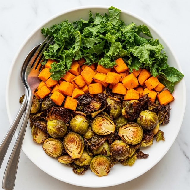 The dish shows a white bowl filled with a colorful roasted vegetable salad. The bottom layer is made up of crispy roasted Brussels sprouts with a golden-brown texture. On top of that, there are bright orange cubes of roasted sweet potato. Fresh green kale leaves are layered among the vegetables, adding a leafy texture. A silver fork and spoon rest on the side of the bowl, placed over a white marbled surface. photo taken with an iphone --ar 4:5 --v 7