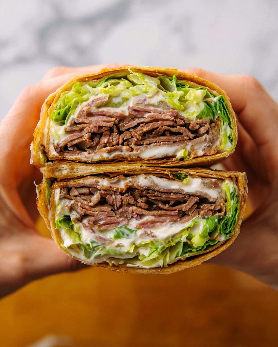 A close-up view of a large wrap sandwich cut in half horizontally, held by two hands on both sides. The wrap has multiple thin layers of dark brown cooked meat stacked tightly in the center, surrounded by creamy white sauce spread unevenly over it. Bright green lettuce leaves add a fresh crunch layer above and below the meat. The wrap bread is golden brown with a slightly crispy texture, wrapping all layers snugly. The background is a white marbled texture. photo taken with an iphone --ar 4:5 --v 7