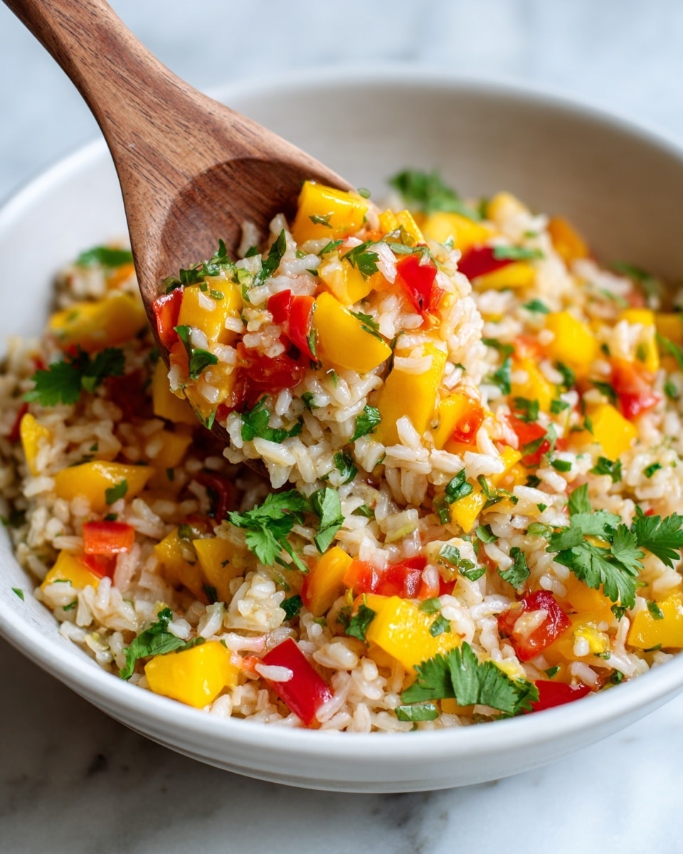 A white plate is filled with a colorful shrimp fried rice dish. The base layer is a mix of golden brown fried rice grains that look slightly glossy. Scattered throughout the rice are bright orange carrot cubes and vivid green peas, adding pops of color. There are also small bits of yellow scrambled eggs mixed evenly into the rice. On top, there are several large, pinkish-orange cooked shrimp with a smooth and slightly shiny texture sitting around the edges. Some chopped green onions are sprinkled on top, adding fresh green highlights. The plate is placed on a white marbled surface, giving a clean and bright background. photo taken with an iphone --ar 4:5 --v 7