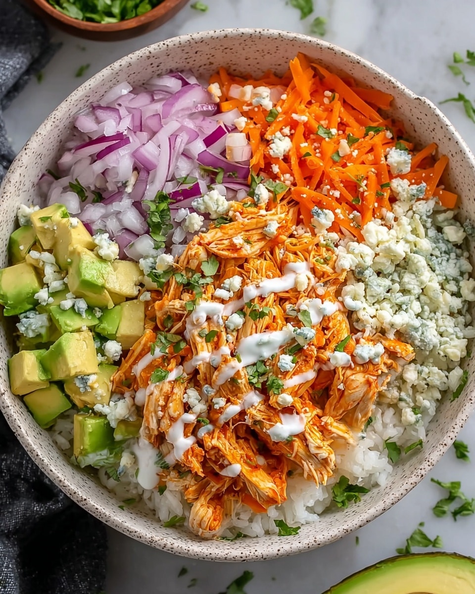 A white speckled bowl filled with a colorful layered salad. The base layer is white rice covering the bottom. On top, shredded orange buffalo chicken is placed slightly to the front center, drizzled with white creamy dressing and sprinkled with green herbs. To the right and left of the chicken, there are diced light green avocados. Behind the chicken, there is a pile of shredded bright orange carrots, while thin slices of purple onion are on the left side. The entire bowl is topped with crumbled white blue cheese and scattered green herbs. The bowl sits on a white marbled surface with some small green herbs scattered around. Photo taken with an iphone --ar 4:5 --v 7
