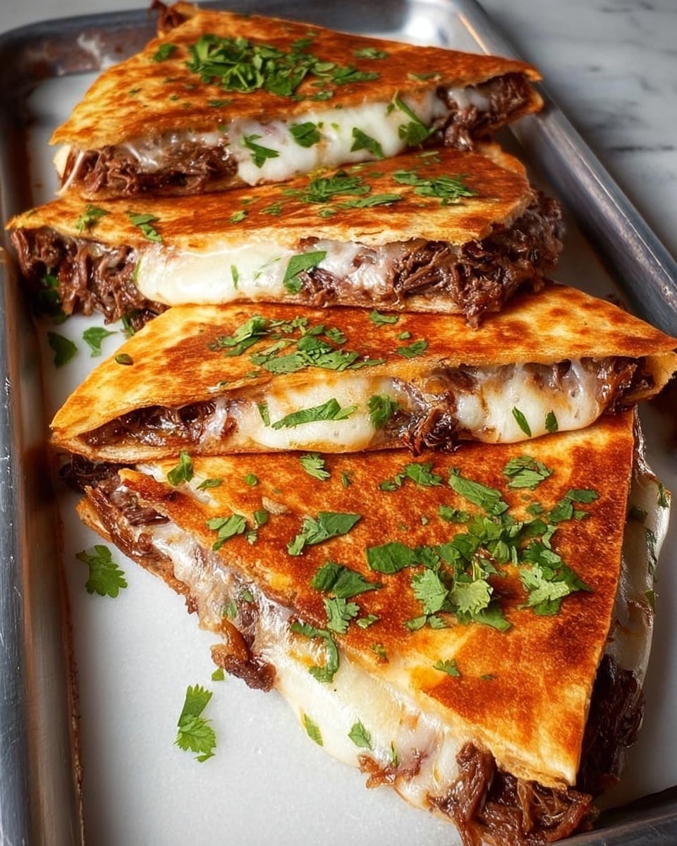 A metal tray holds four triangular quesadilla slices stacked slightly on top of each other. Each slice has a golden-brown crispy outer layer, with melted white cheese beneath it. The middle layer is filled with shredded brown meat mixed with small white onion pieces. Fresh green chopped herbs are sprinkled over the quesadillas and around the tray. The tray sits on a white marbled surface with part of a woman's black sleeve visible in the background. photo taken with an iphone --ar 4:5 --v 7