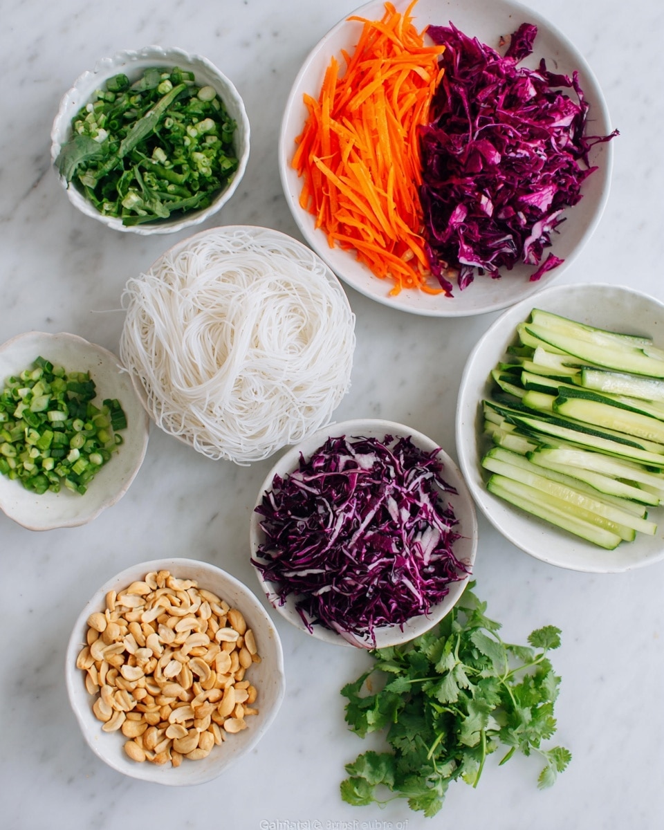 The image shows seven white bowls and plates placed on a white marbled surface, each holding different fresh ingredients. There are thin white rice noodles laid flat on the surface in one area. Around them, vibrant orange carrot sticks fill one plate, while a bowl contains crisp, dark purple shredded cabbage with white veins. Another bowl holds fresh green cucumber sticks, and a smaller bowl has finely chopped green onions. A small plate is filled with light brown roasted peanuts. Fresh green cilantro leaves are placed on the surface at two spots, adding a natural leafy touch. The colors and textures create a fresh and colorful look. Photo taken with an iphone --ar 4:5 --v 7